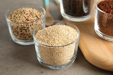 Photo of Glass with white quinoa on grey table