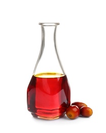 Photo of Palm oil in glass bottle and fruits isolated on white