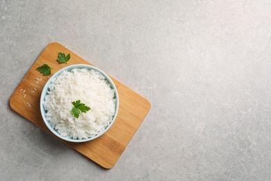 Photo of Bowl of delicious rice on table, top view with space for text