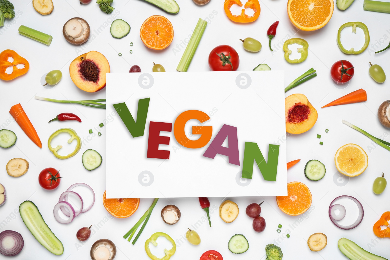 Image of Paper card with word Vegan, fresh vegetables and fruits on white background, flat lay