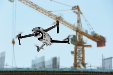 Image of Modern drone flying at building site. Aerial survey