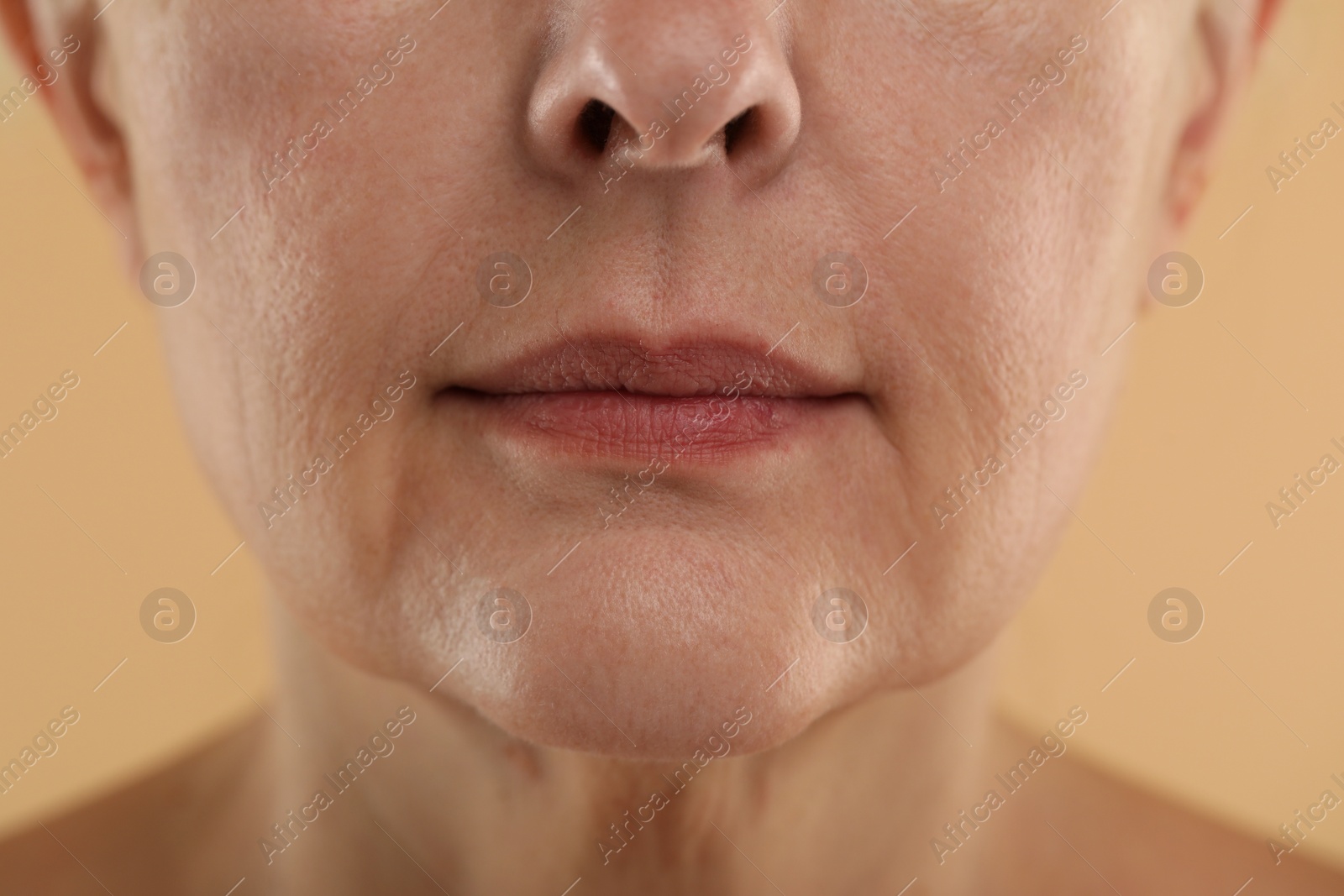 Photo of Woman with normal skin on beige background, macro view