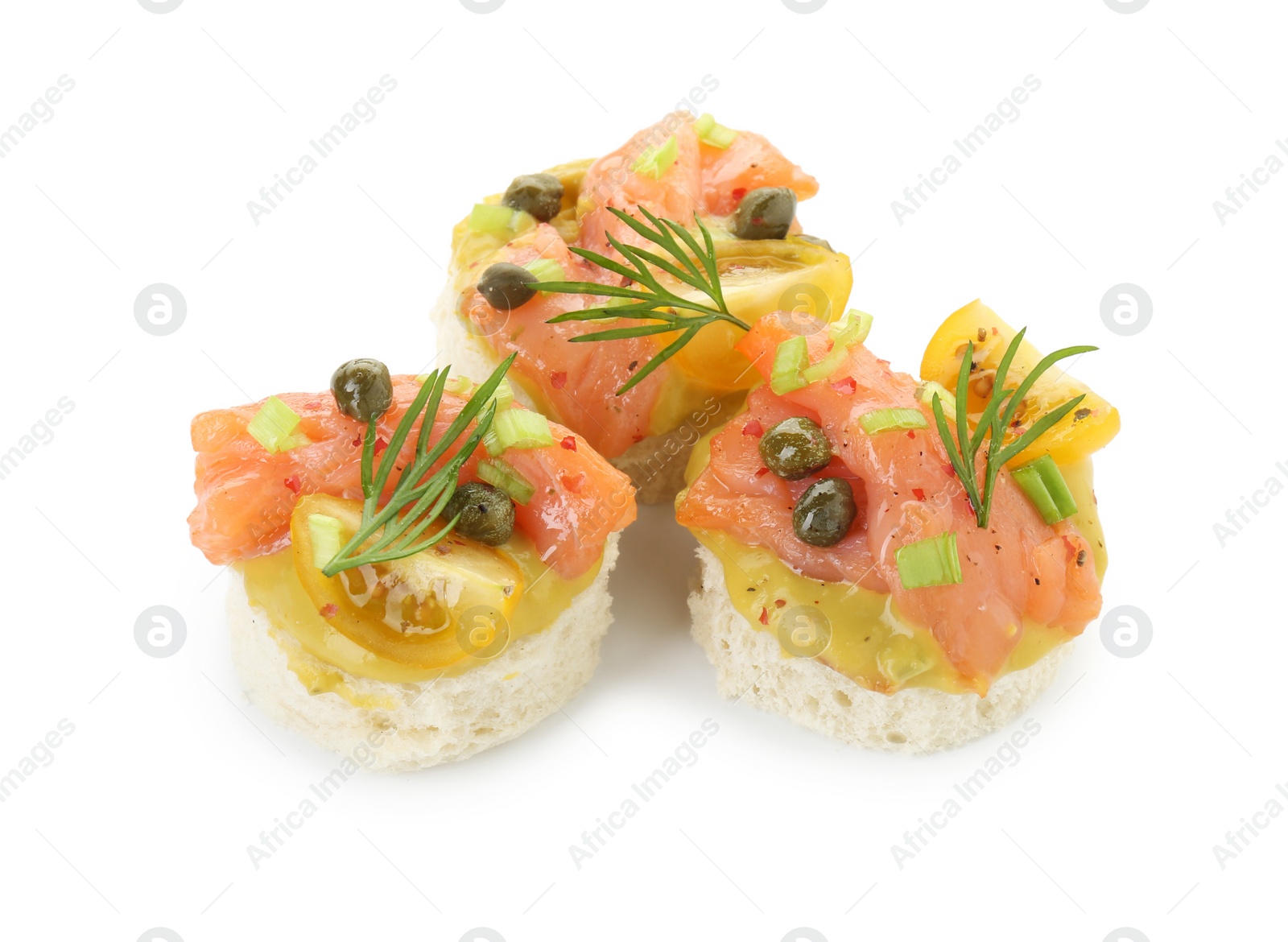 Photo of Tasty canapes with salmon, tomatoes, capers and herbs isolated on white