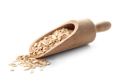 Photo of Scoop with raw oatmeal on white background. Healthy grains and cereals