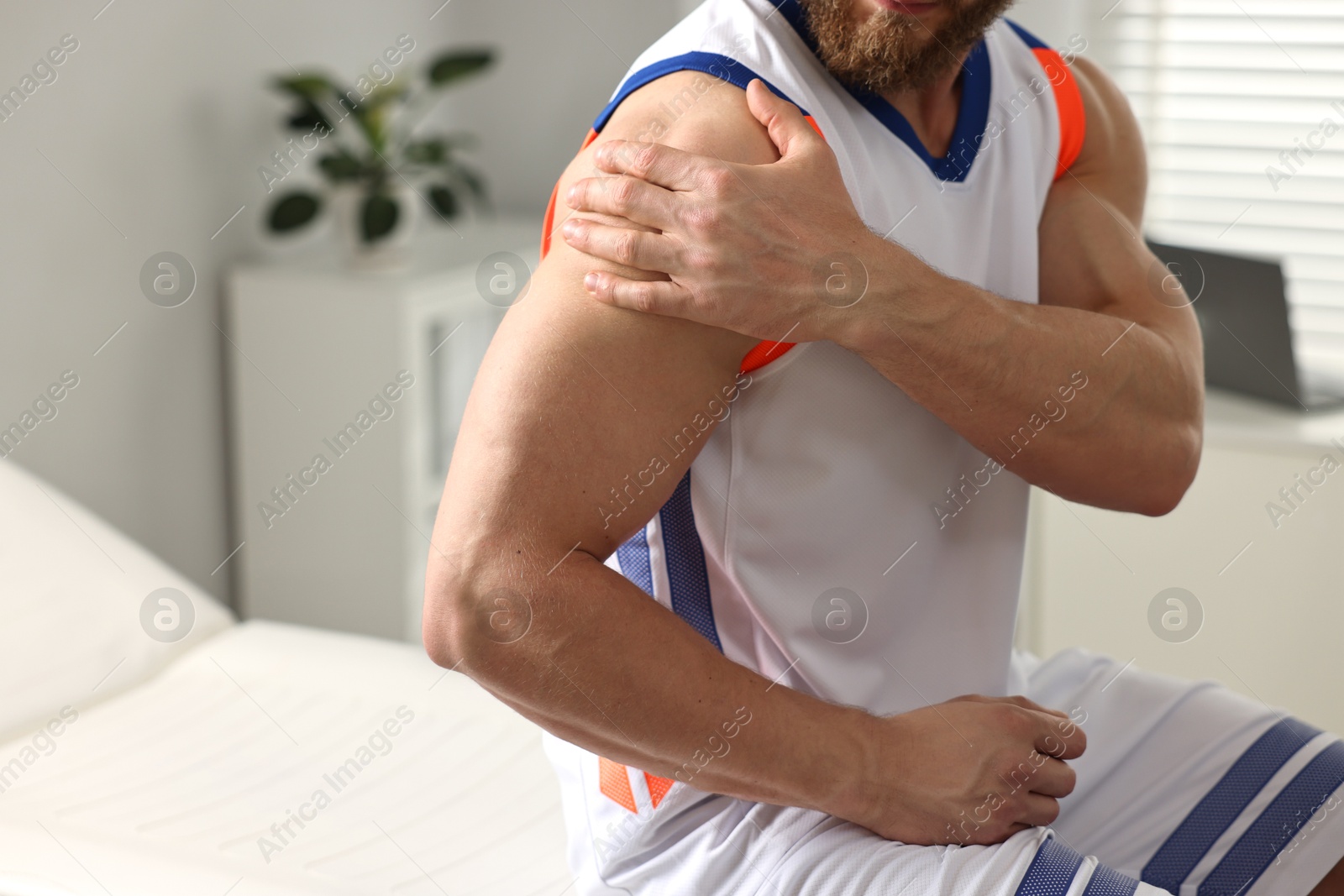 Photo of Sportsman with injured shoulder in hospital, closeup. Space for text