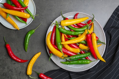 Photo of Flat lay composition with chili peppers on grey background