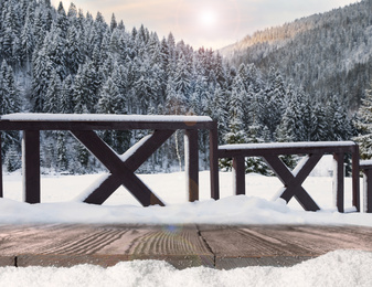 Wooden surface and beautiful view of winter landscape 