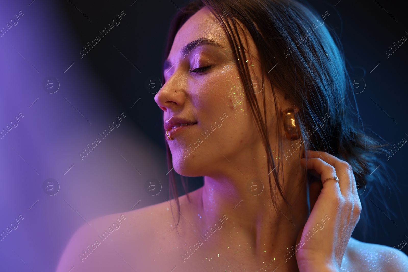 Photo of Portrait of beautiful woman on dark background in neon lights