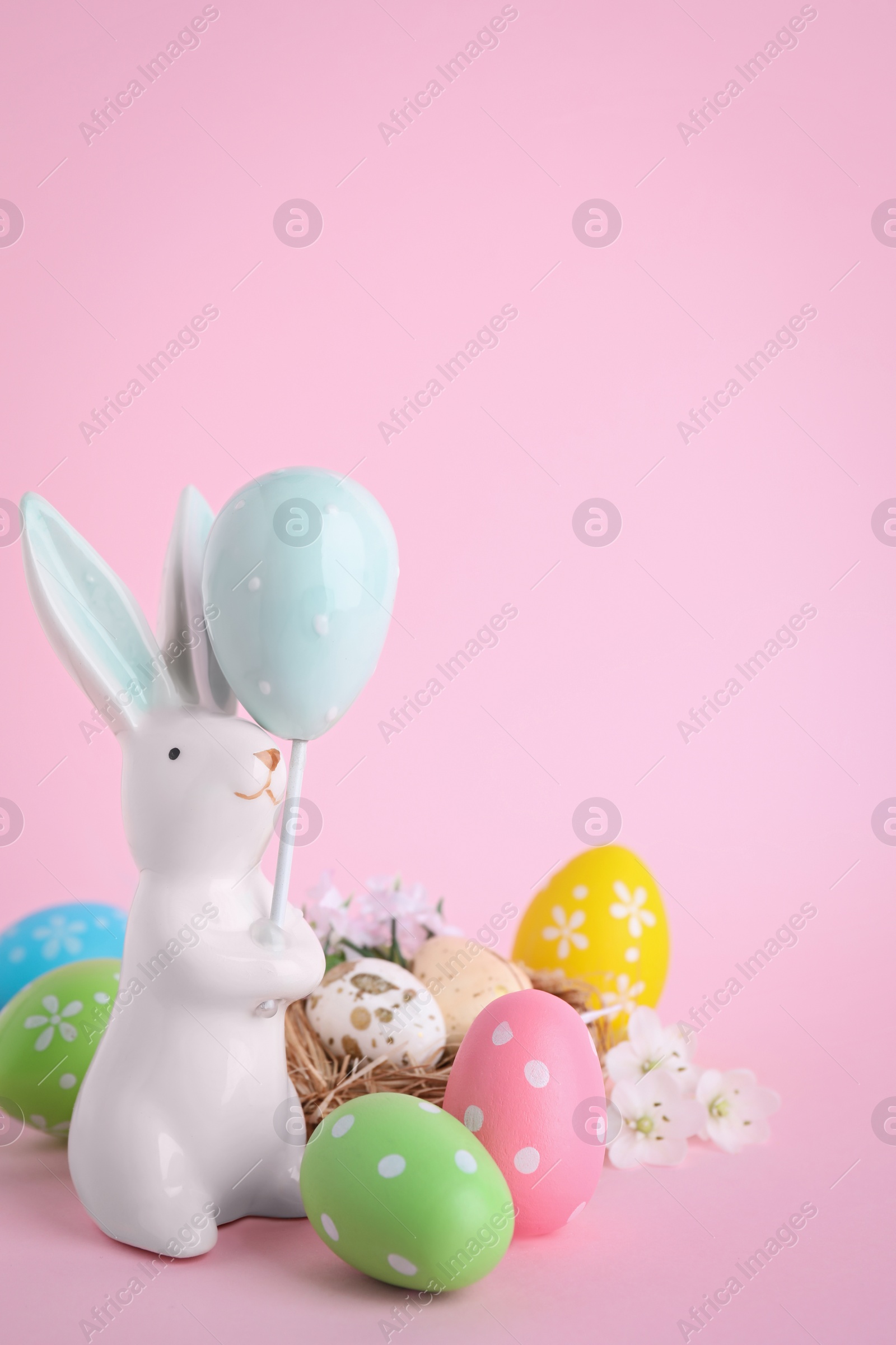 Photo of Composition with Easter bunny figure on pink background