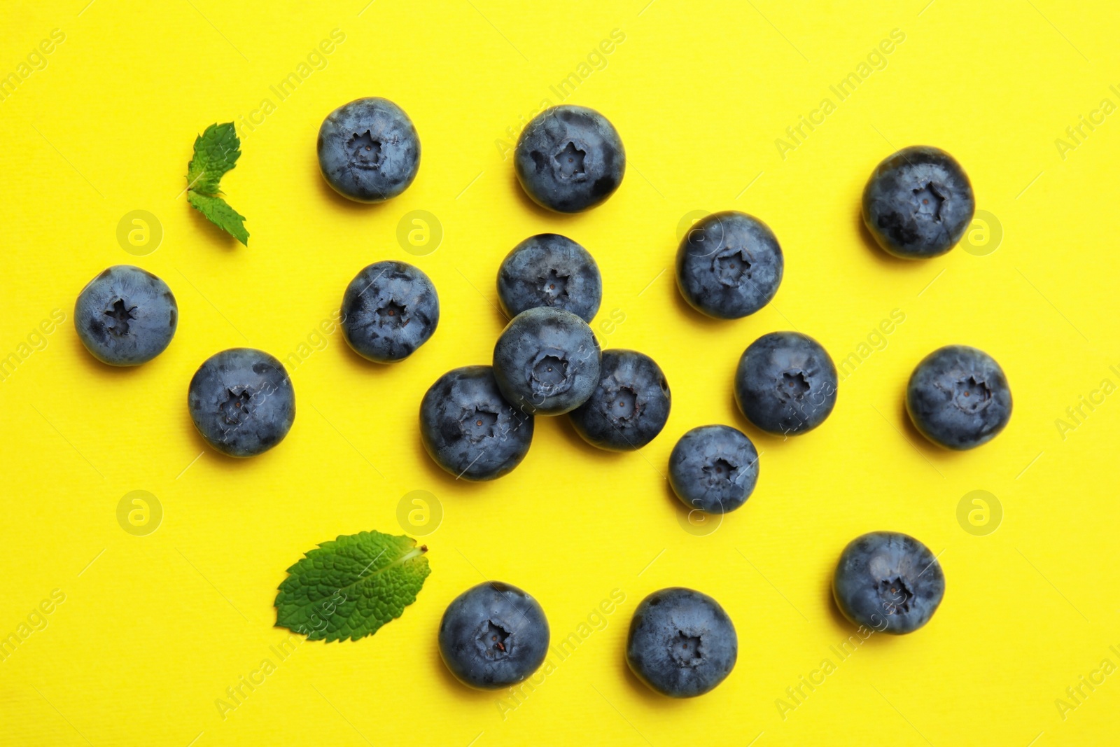 Photo of Flat lay composition with tasty blueberry on color background