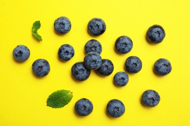 Flat lay composition with tasty blueberry on color background