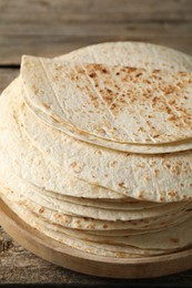 Stack of tasty homemade tortillas on wooden table