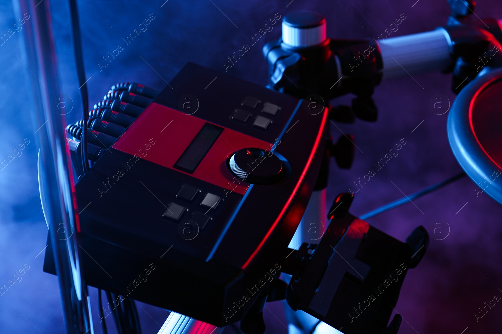 Photo of Modern electronic drum module and smoke on dark background. Musical instrument