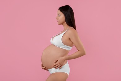 Photo of Beautiful pregnant woman in stylish comfortable underwear on pink background