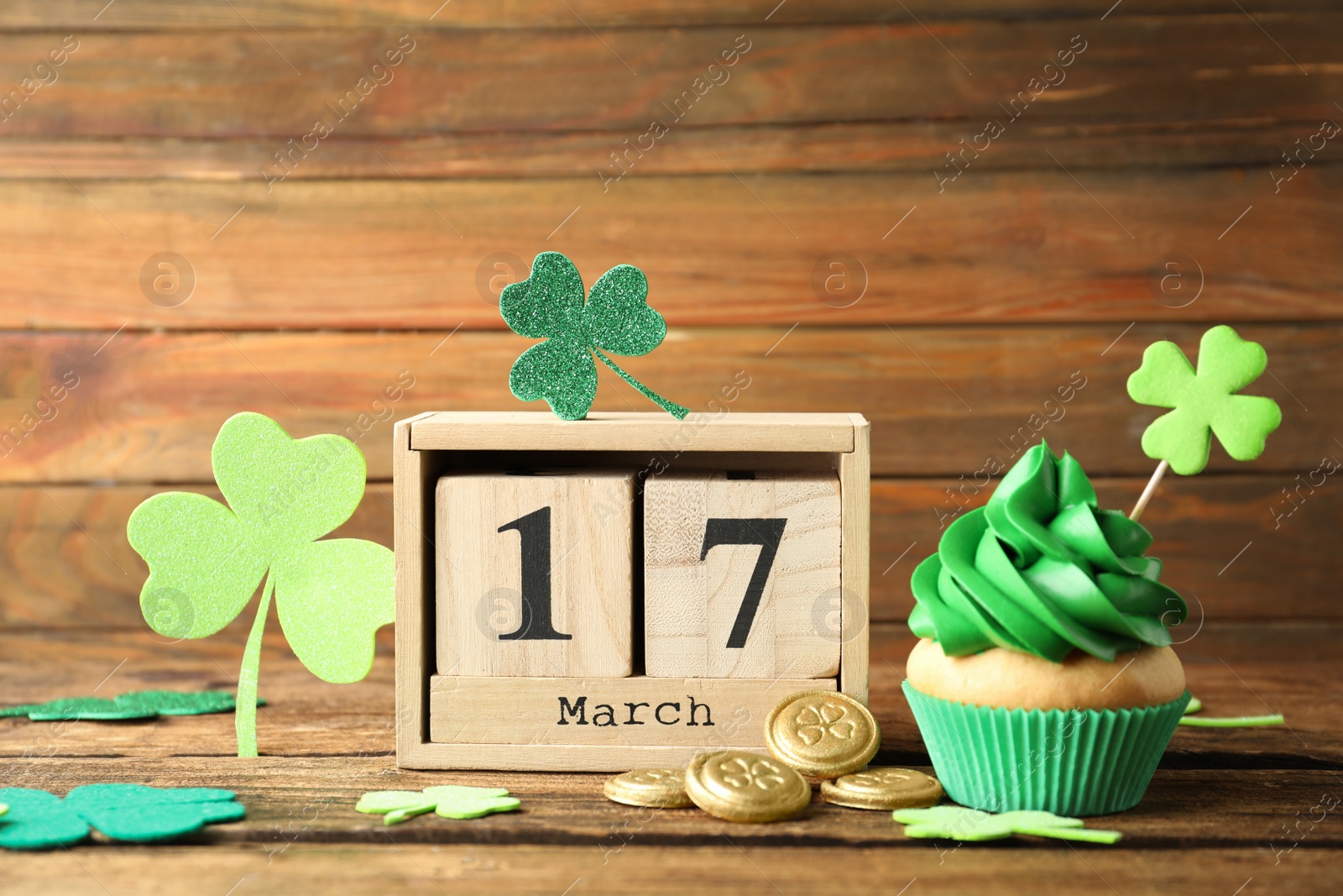 Photo of Composition with block calendar on wooden table. St. Patrick's Day celebration