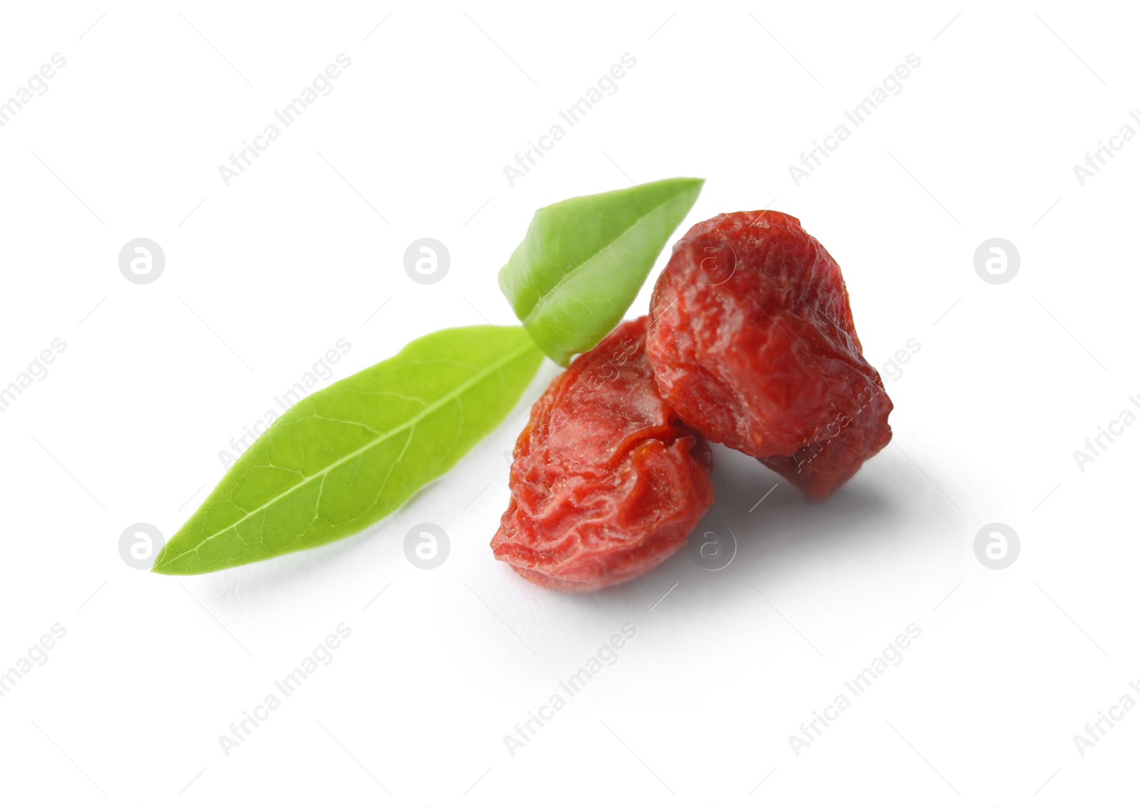 Photo of Tasty dried goji berries and leaves isolated on white