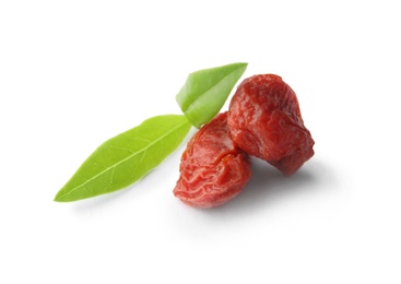 Photo of Tasty dried goji berries and leaves isolated on white