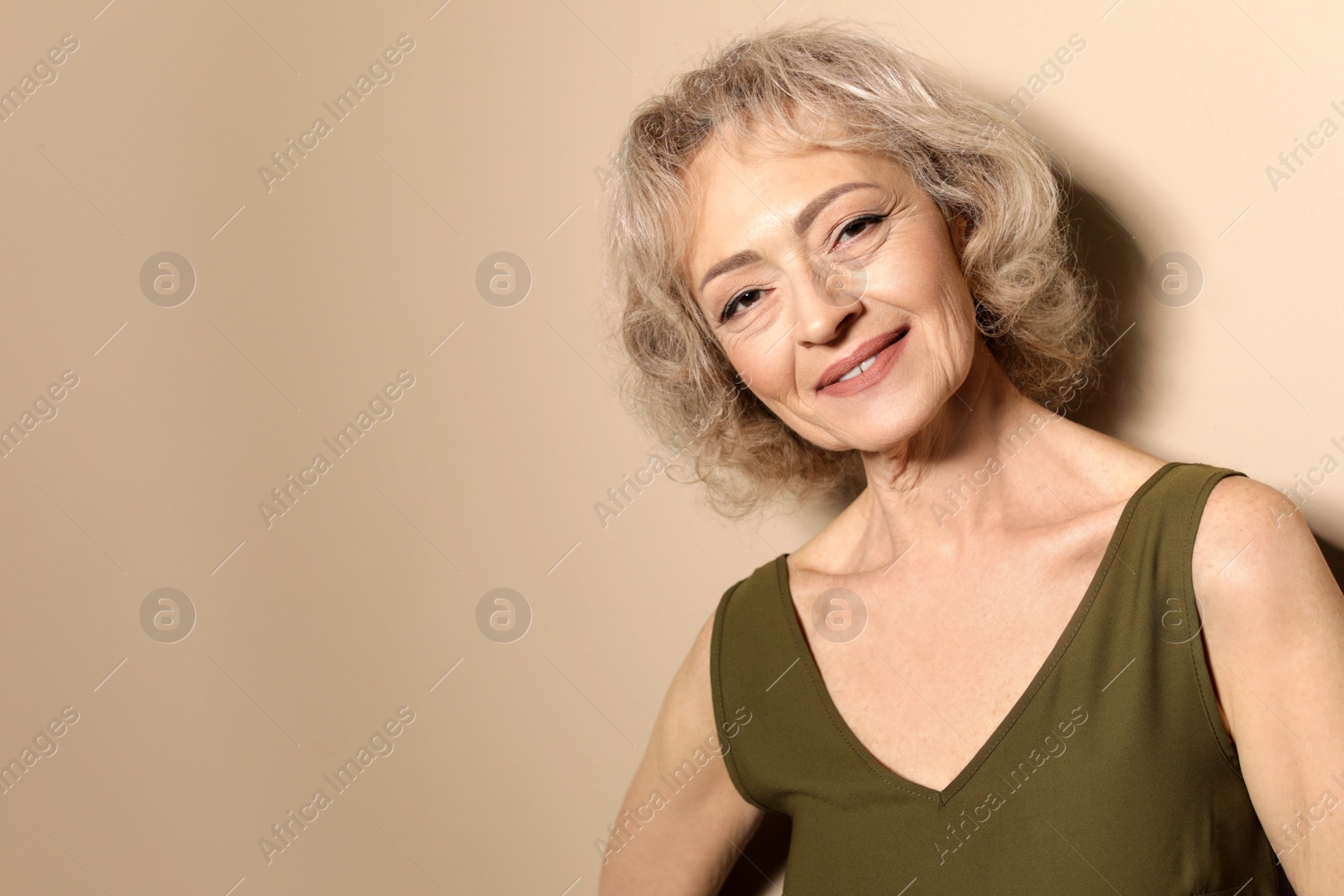 Photo of Portrait of mature woman on color background. Space for text