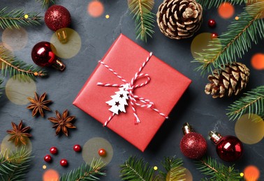 Photo of Flat lay composition with beautiful gift box and different Christmas decor on dark background