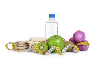 Healthy food, measuring tape and dumbbells on white background. Concept of weight loss