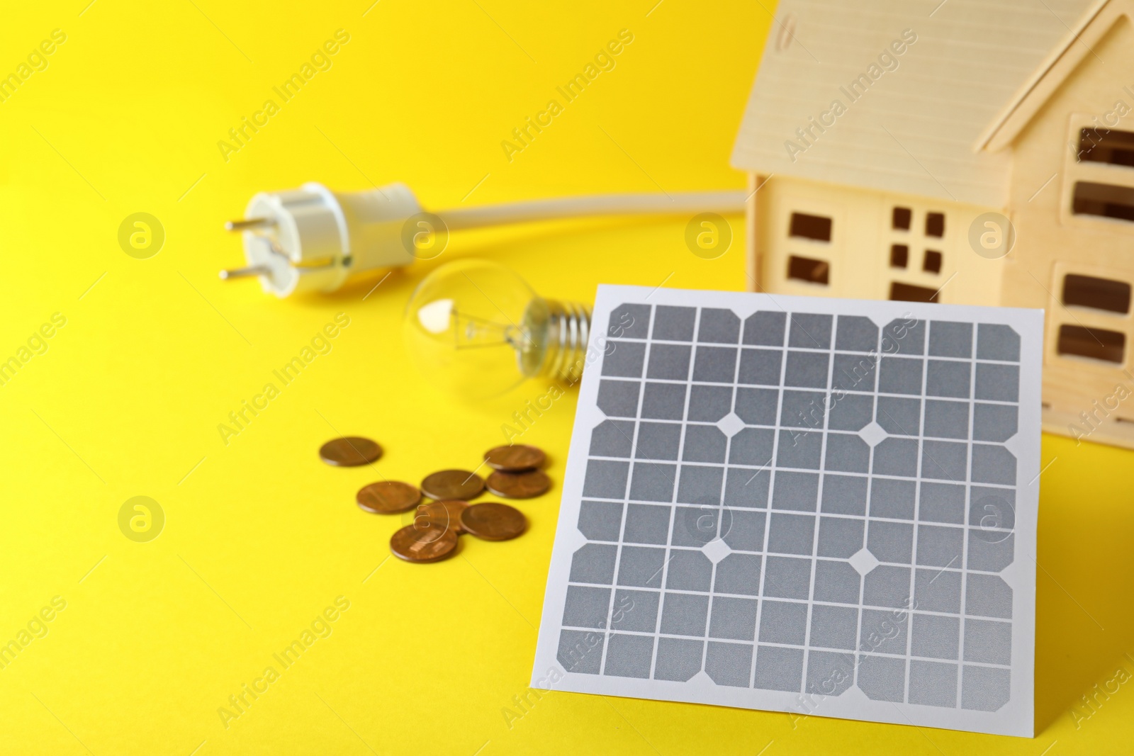 Photo of Composition with solar panel on yellow background. Space for text