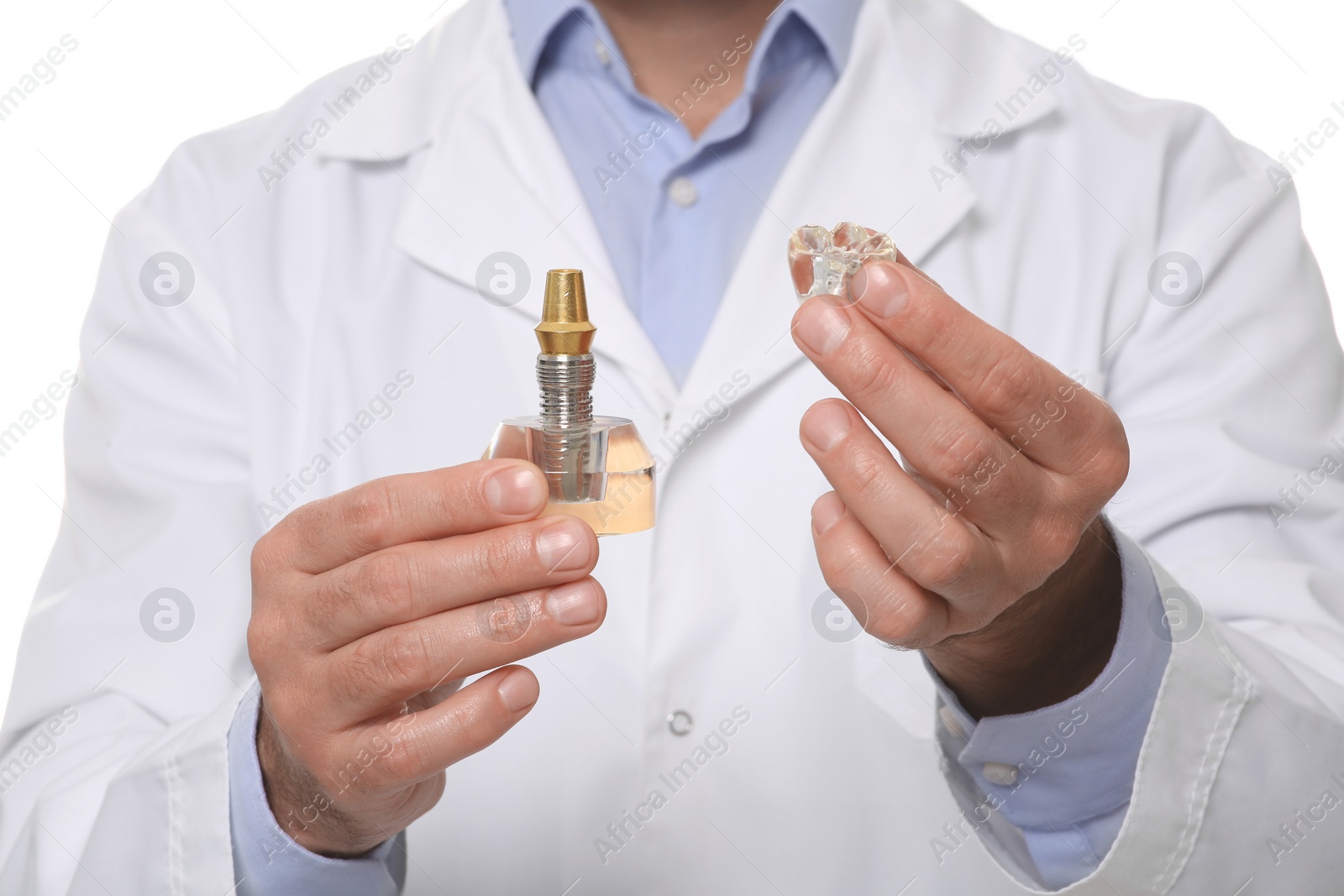 Photo of Dentist holding educational model of dental implant on white background, closeup