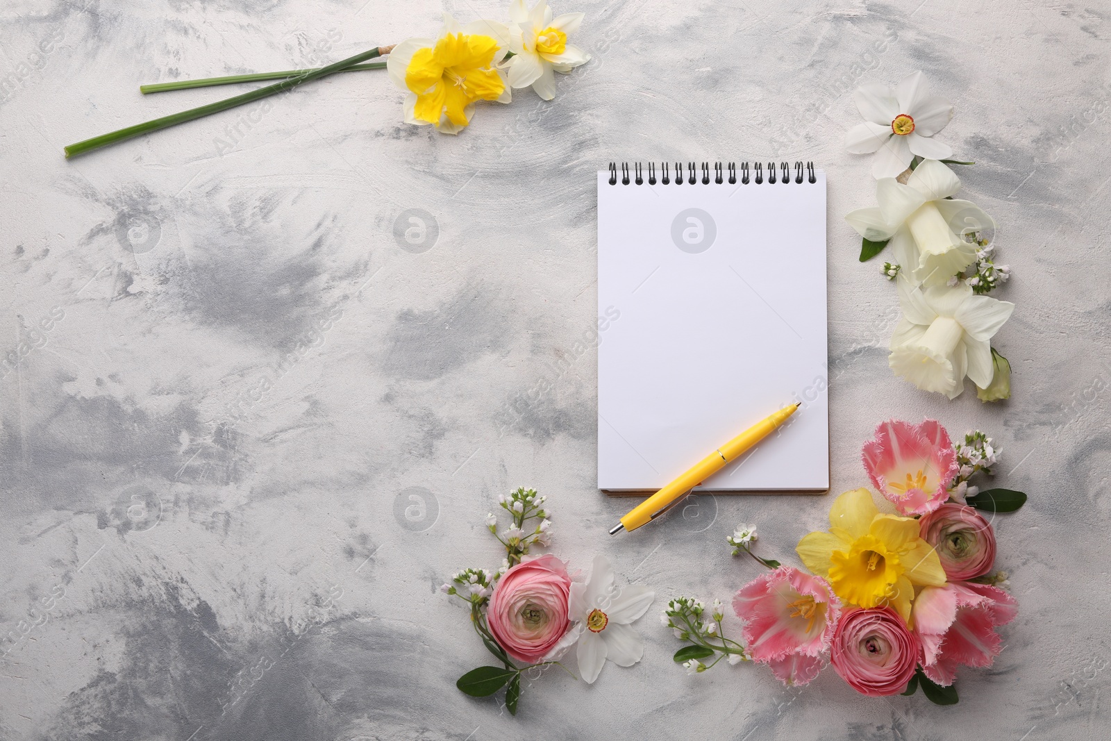 Photo of Guest list. Notebook, pen and beautiful flowers on gray textured background, flat lay. Space for text