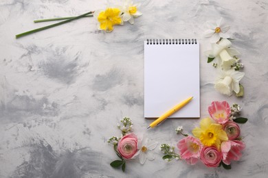 Guest list. Notebook, pen and beautiful flowers on gray textured background, flat lay. Space for text