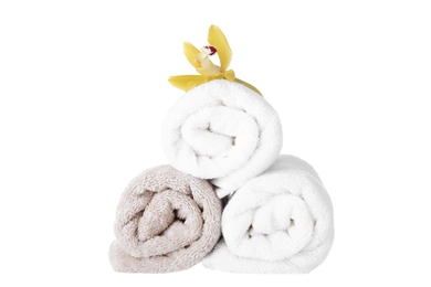 Photo of Fresh towels and exotic flower isolated on white
