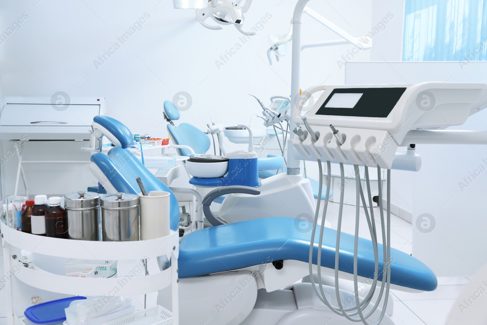 Photo of Dentist's office interior with chair and modern equipment