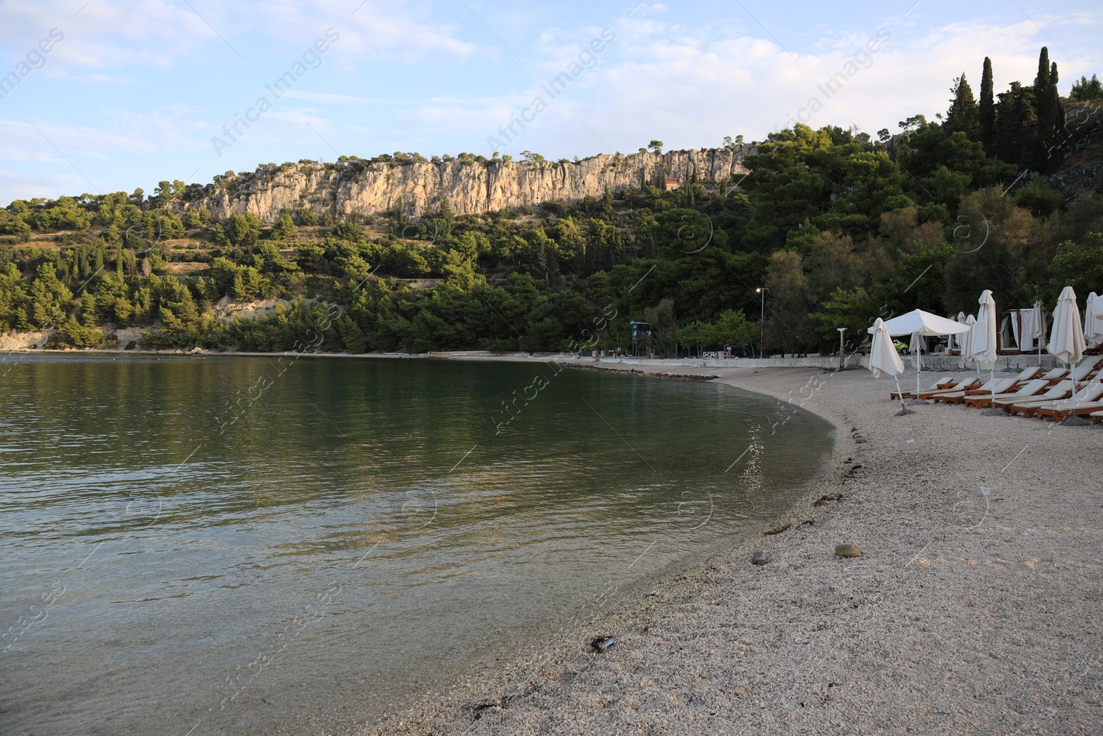 Photo of Many beach umbrellas and sunbeds at resort