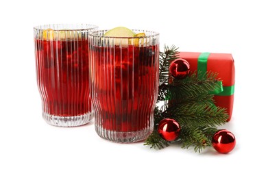 Photo of Aromatic Sangria drink in glasses and Christmas decor isolated on white