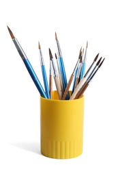 Photo of Holder with different paint brushes on white background