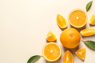 Photo of Flat lay composition with ripe oranges and space for text on color background