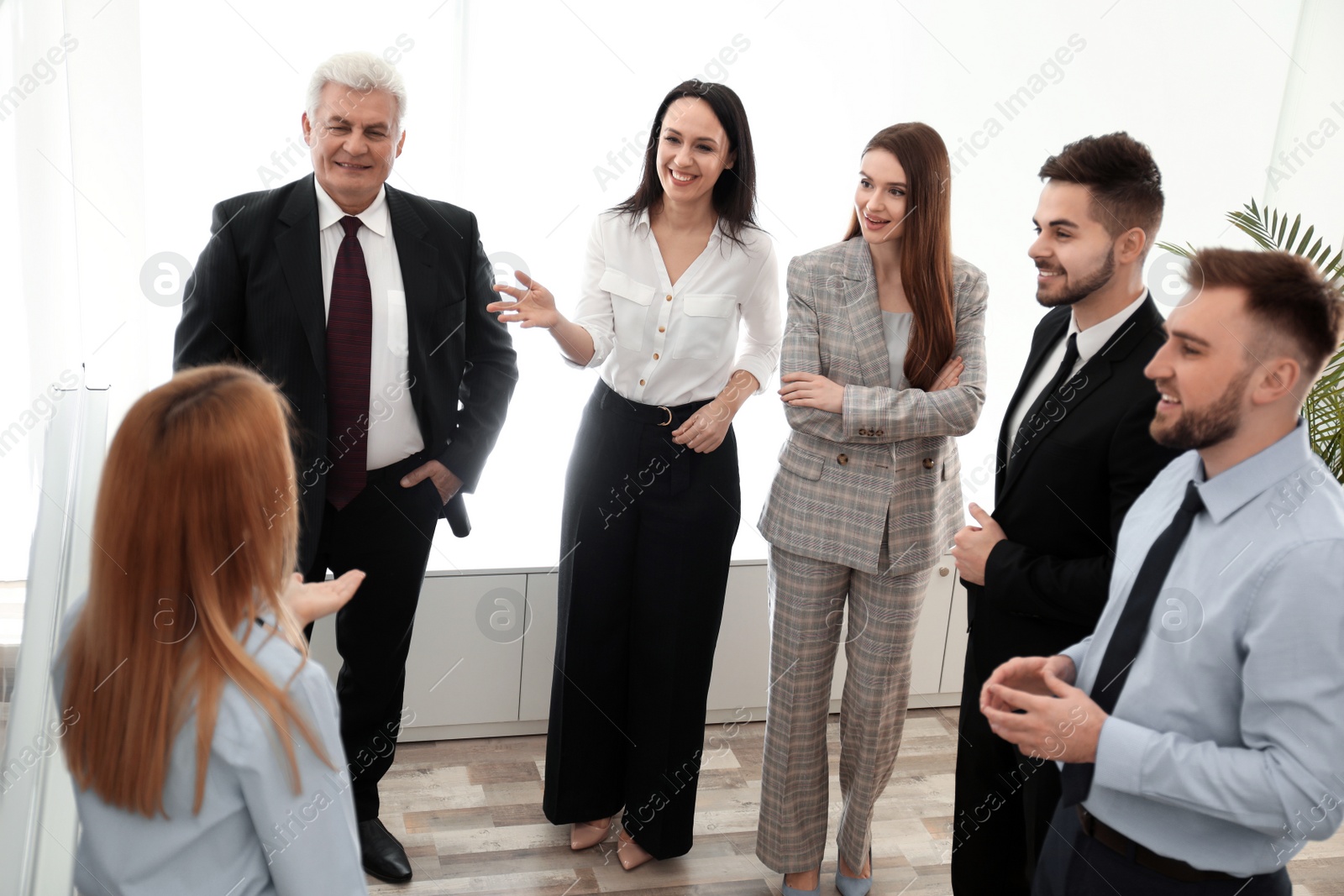 Photo of Professional business trainer working with people in office