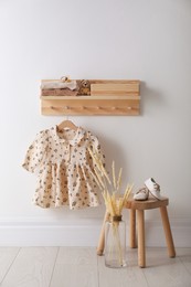 Cute children's clothes and shoes in room