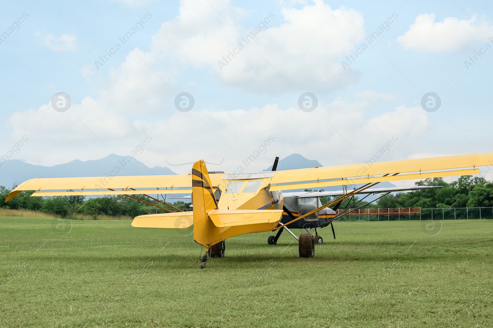 Photo of View of beautiful ultralight airplanes in field on autumn day