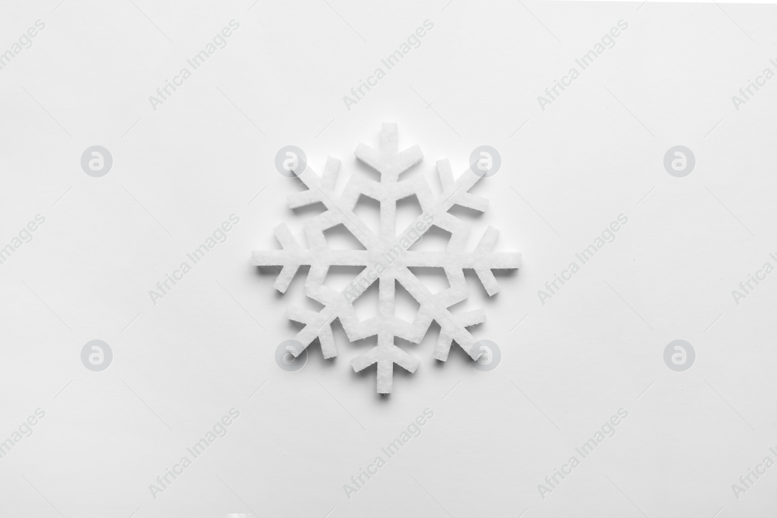 Photo of Beautiful decorative snowflake on white background, top view