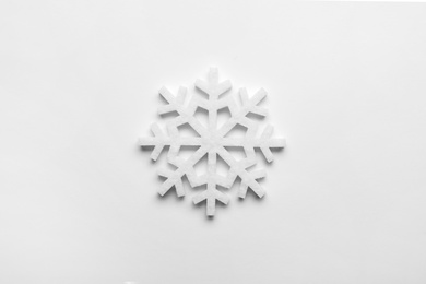 Photo of Beautiful decorative snowflake on white background, top view