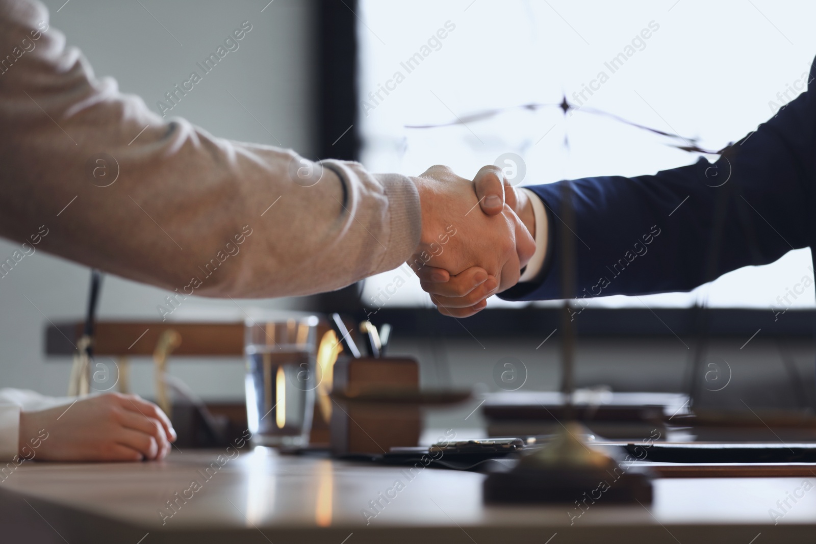 Photo of Male lawyer working with clients in office, closeup