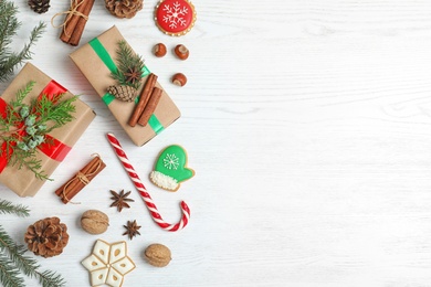 Flat lay composition with Christmas gift boxes on white wooden background. Space for text