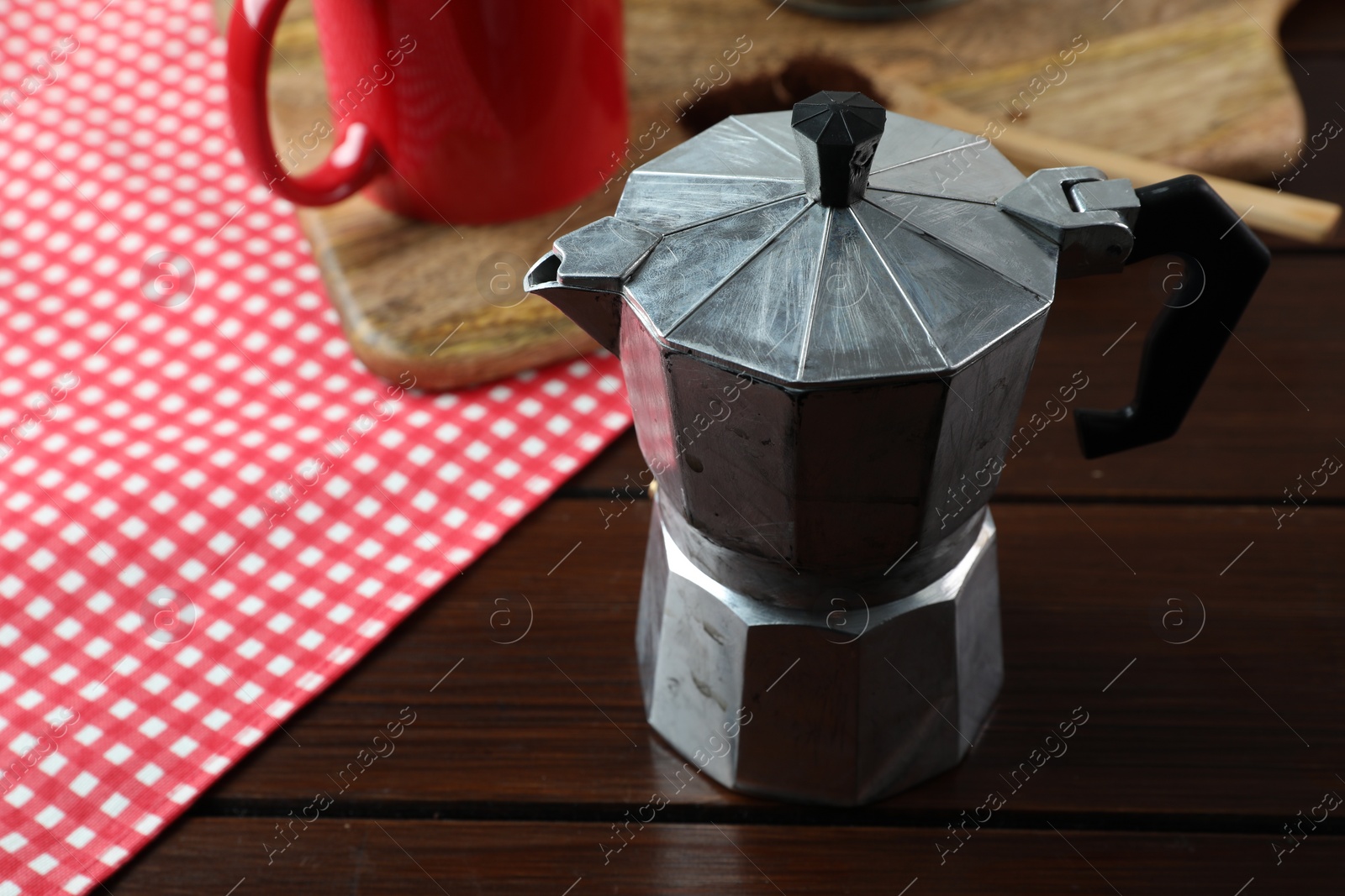 Photo of One moka pot on wooden table, closeup