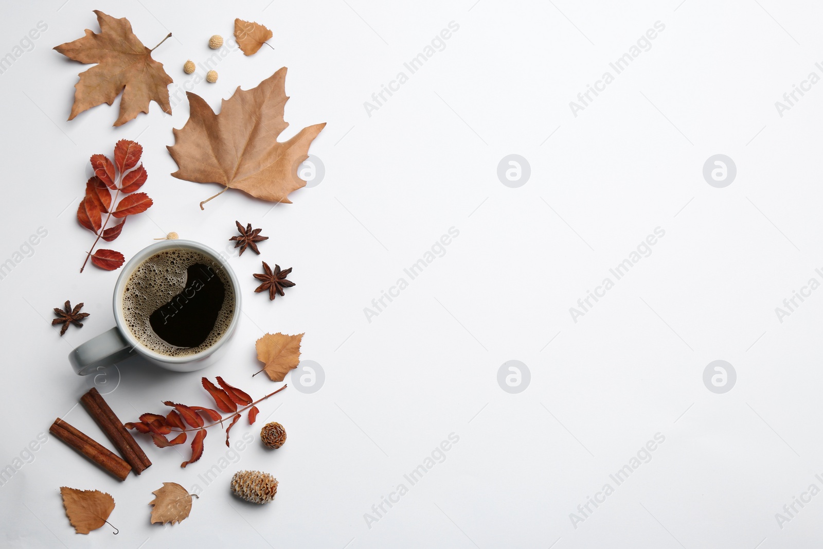 Photo of Flat lay composition with cup of hot drink and autumn leaves on white background, space for text. Cozy atmosphere