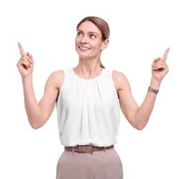 Beautiful happy businesswoman pointing at something on white background