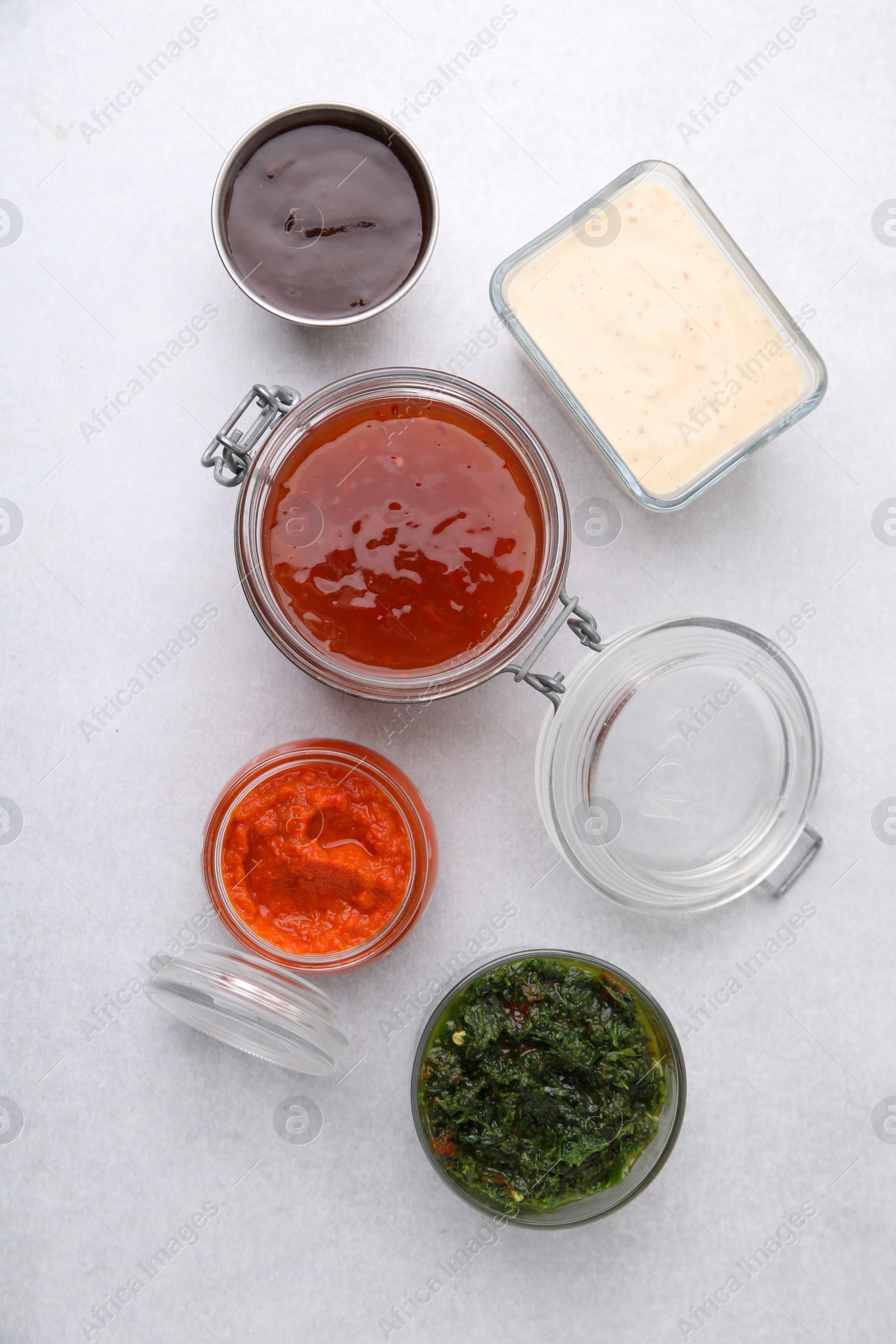 Photo of Different marinades on light table, flat lay