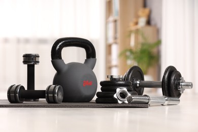 Photo of Many different sports equipment on floor indoors