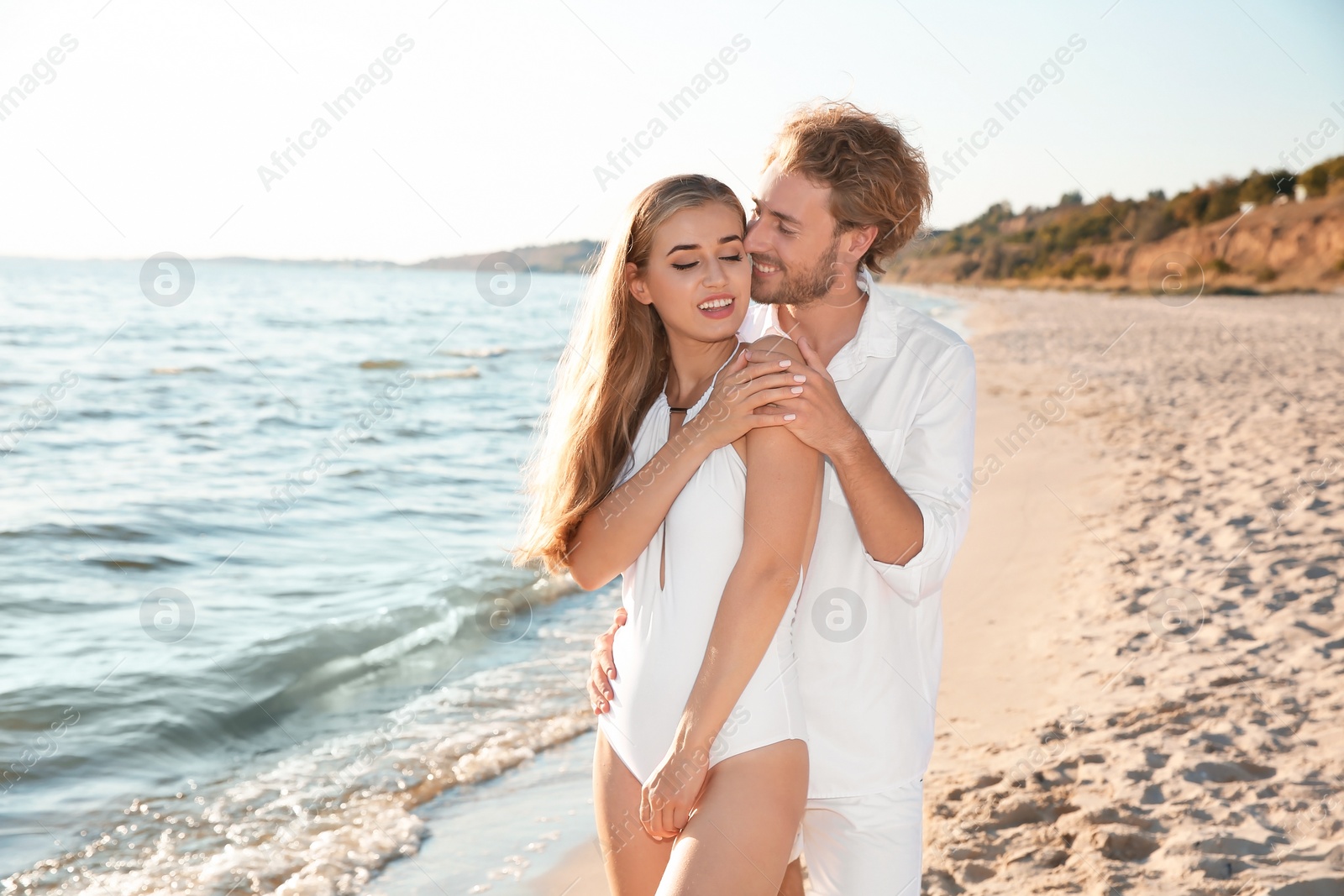 Photo of Romantic young couple spending time together on beach