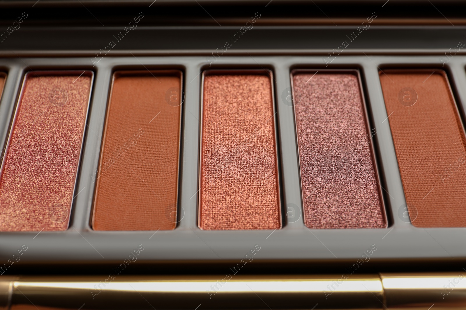 Photo of Beautiful eye shadow palette with brush as background, closeup