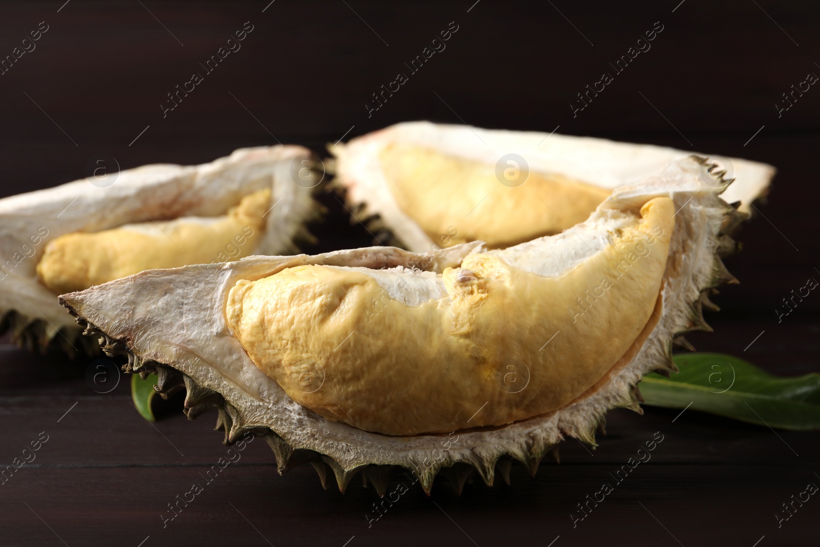 Photo of Fresh ripe durian on wooden table, closeup