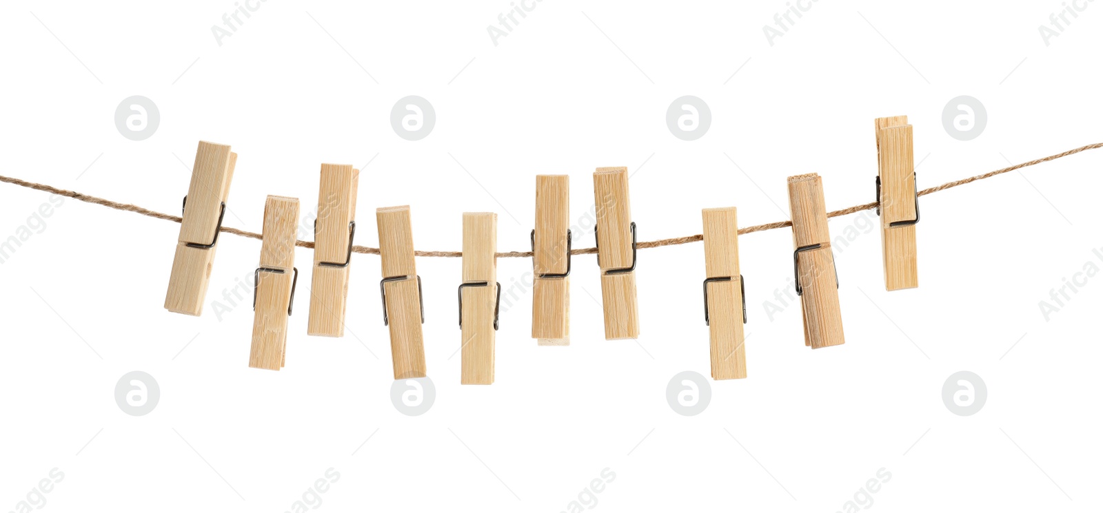 Photo of Many wooden clothespins on rope against white background